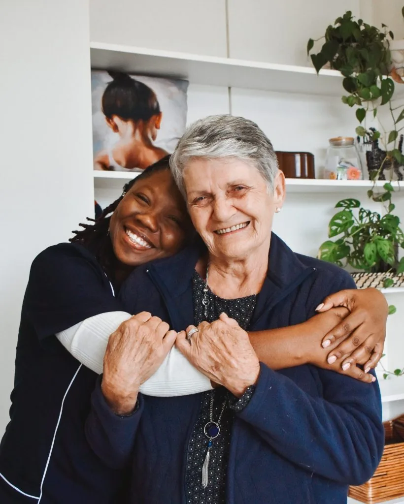 A Kriel caregiver and client sharing an embrace